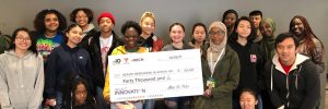 Students of Project LEAH pose with the oversize Project Innovation grant check.
