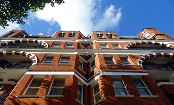 brownstones buildings reaching toward a blue sky